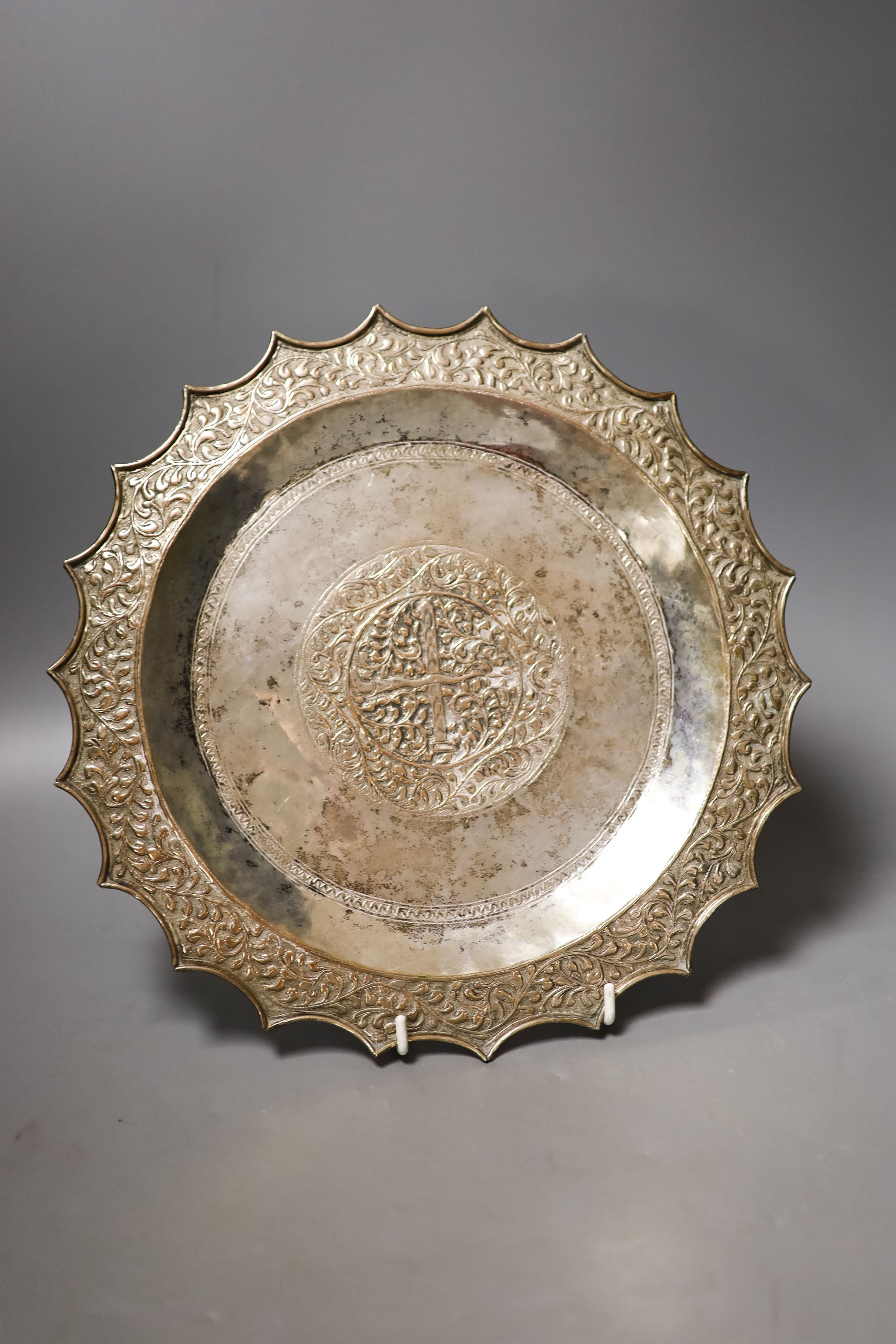 A Thai? white metal salver, with wavy border, 29cm